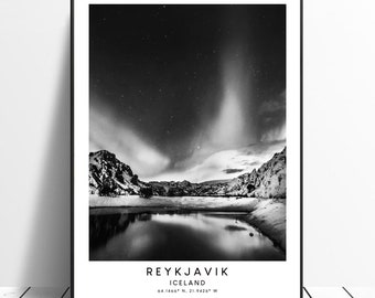 May include: Black and white photograph of a mountain range with a lake reflecting the night sky. The aurora borealis is visible in the sky. The text "REYKJAVIK ICELAND 64.1460° N, 21.9420° W" is at the bottom of the image.