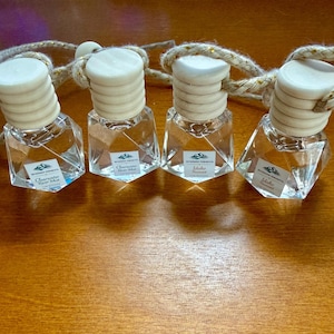 May include: A rustic wooden sign with the text "Welcome to our home" in white lettering. The sign has a distressed finish and a simple, inviting design, suitable for a front porch or entryway.