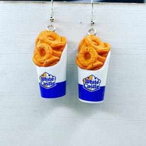 May include: A pair of dangle earrings featuring White Castle-themed charms. Each charm is a small white paper cup with a blue and yellow logo and a depiction of fried onion rings.