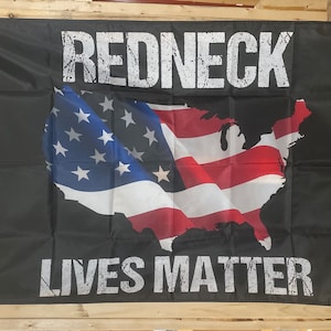 May include: Black flag with a white outline of the United States of America with red and white stripes and blue stars. The text "REDNECK LIVES MATTER" is printed in white on the flag.