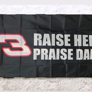 May include: Black flag with a white number "3" and the text "Raise Hell Praise Dale" in white letters.