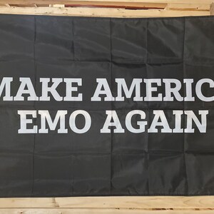 May include: Black flag with white text that reads "MAKE AMERICA EMO AGAIN".