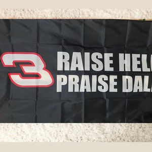 May include: Black flag with a white number "3" in a red outline and the text "RAISE HELL PRAISE DALE" in white.