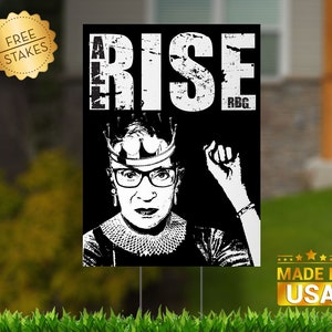 May include: Black and white image of Ruth Bader Ginsburg wearing a crown and glasses with her fist raised. The text "Rise" and "RBG" are on the image.