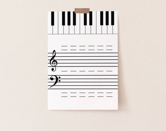 May include: A white sheet of music paper with a treble clef and a bass clef printed on it. The paper is attached to a wall with a piece of tape. The paper has lines for writing music notes.