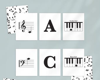 May include: A set of white flashcards with black musical notes, letters, and piano keys. The text "PIANO NOTE FLASHCARD SET" is at the top. The cards include treble and bass clef, the letters A and C, and piano key diagrams.