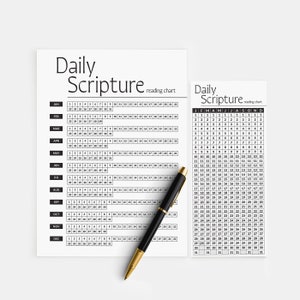 May include: A black and white printable daily scripture reading chart with a pen on top of it. The chart is divided into two sections, one for each month of the year. The chart is designed to help people read through the Bible in a year.