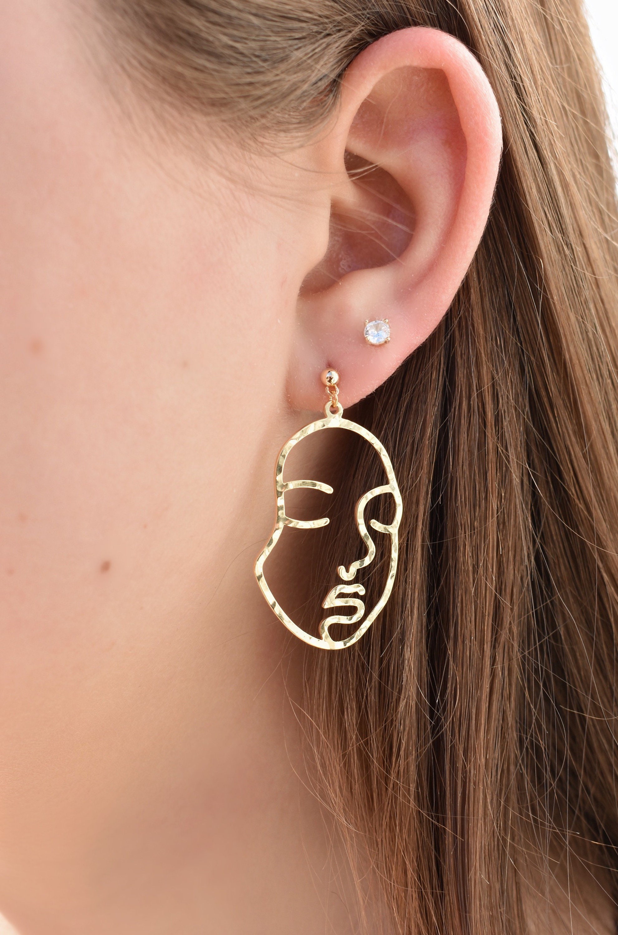 Face gold earrings deals