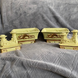 May include: Two green ceramic planter pots with gold accents and a dragon design. Each pot sits on a base with a gold trim. Two matching green ceramic candle holders with gold accents and a dragon design.
