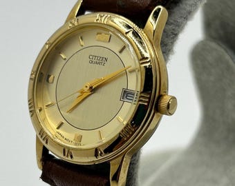 Reloj de cuarzo vintage Citizen 1012-K13131 CKK para mujer, con caja dorada, bisel con números romanos y fecha.