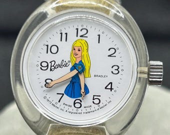 Reloj mecánico coleccionable vintage de Barbie Bradley de 1973, con brazos y manos móviles, de Mattel. Fabricado en Suiza.