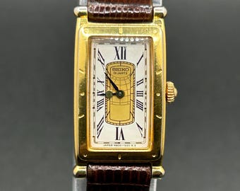 Reloj de cuarzo vintage Seiko "Age of Discovery" 4N00-5509 con esfera romana rectangular en tono dorado para mujer.