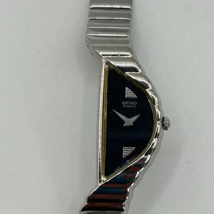 Vintage Seiko half moon stainless steel asymmetrical women’s quartz watch 1F20-5D59