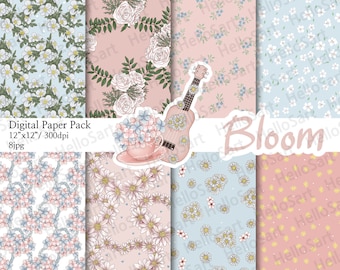 May include: A digital paper pack with eight floral patterns in pink and blue. The patterns include daisies, roses, and forget-me-nots. The text "Bloom" is featured in the center of the image.