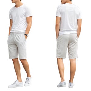 May include: A white t-shirt and grey shorts. The shorts have an elastic waistband and pockets.