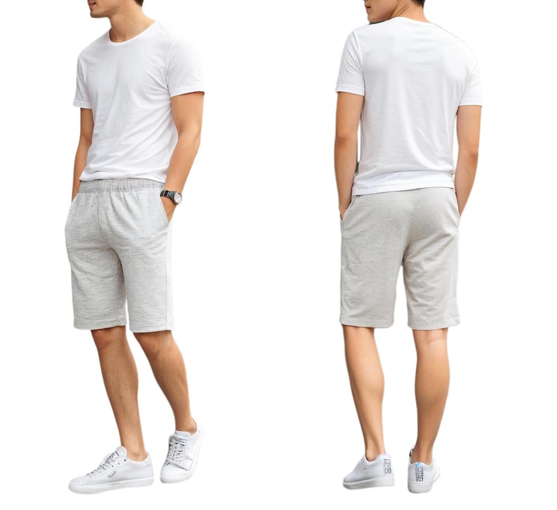 May include: A white t-shirt and grey shorts. The shorts have an elastic waistband and pockets.