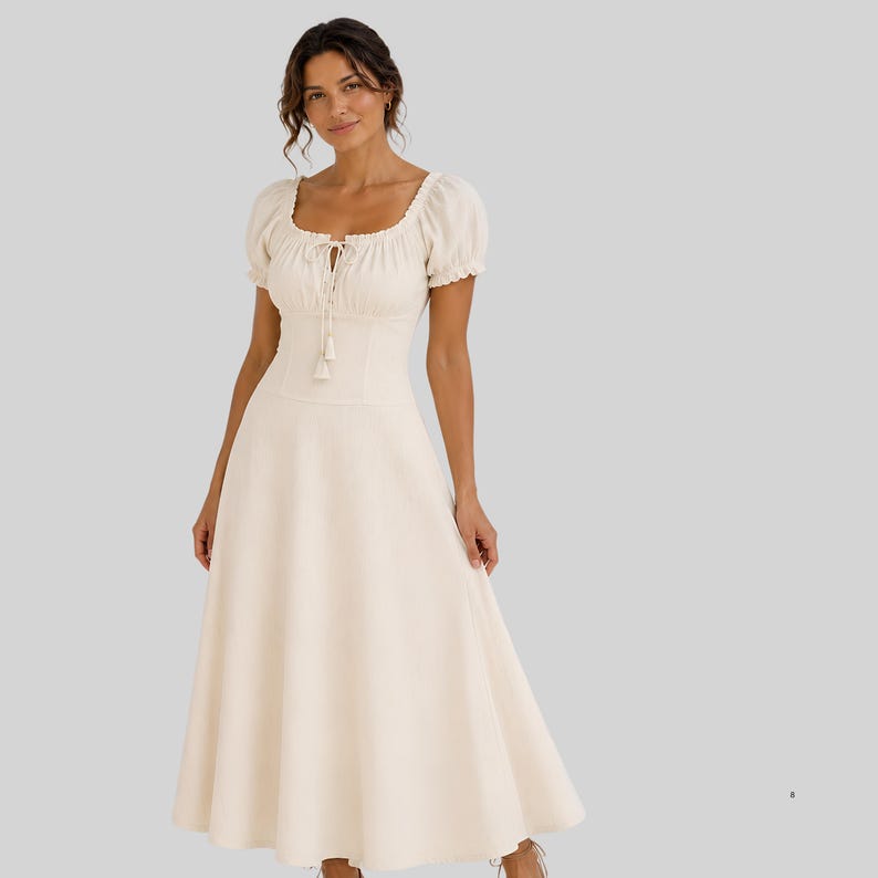 May include: A cream-colored midi dress featuring short puff sleeves, a square neckline with a drawstring tie closure, and a fitted bodice that transitions into a flared, A-line skirt. The garment has a clean, solid-colored fabric construction.