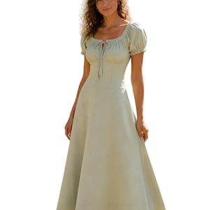 May include: A sage green midi dress featuring a square neckline with a central drawstring tie, short puff sleeves with elasticated cuffs, a fitted bodice, and a flowing A-line skirt that extends to the mid-calf, crafted in a solid light green fabric.