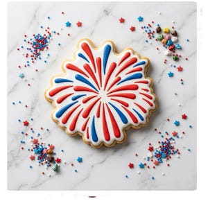 May include: A decorated sugar cookie in the shape of a firework, with red and blue icing radiating from the center. The cookie is surrounded by star-shaped sprinkles and colorful candies on a white marble surface.
