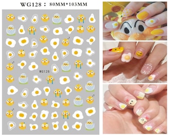 May include: Nail art stickers featuring a cute chick and egg design. The stickers depict yellow chicks with various expressions, including sleeping, crying, and smiling. There are also white egg shapes with yellow yolks. The stickers are arranged on a sheet labelled "WG128: 80MM*103MM".