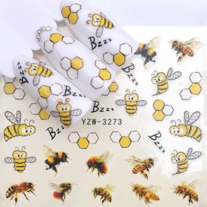 May include: A sheet of nail art stickers featuring bees, honeycombs, and the word "Bzzz" repeated multiple times. The stickers are on a white background.