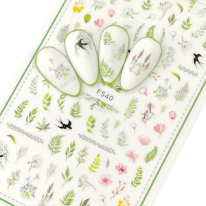 May include: Nail art stickers featuring a floral and leaf design. The stickers include small birds, flowers, and leaves in shades of green, pink, and blue. The stickers are on a clear sheet with a white background. The sheet has the text "F540" printed on it.