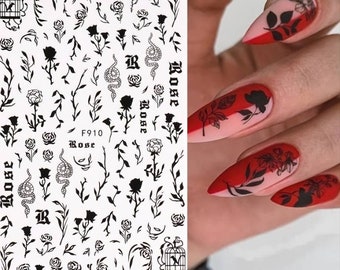 May include: Black and white nail art stickers featuring roses, snakes, cages, and the word "Rose".