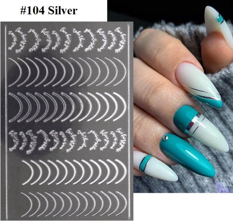 May include: Silver nail art stickers with a variety of curved and floral designs. The sticker sheet is labeled #104 Silver.