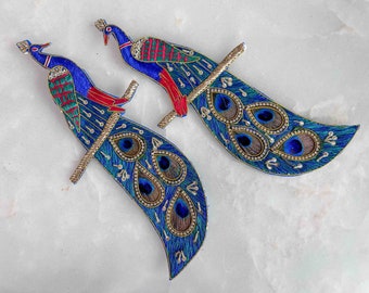 May include: Two blue and green peacock embroidery patches with red accents and gold detailing. The peacocks have elaborate tail feathers with blue and green eyes.