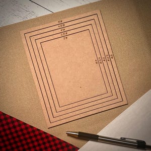 May include: A set of five brown cardboard squares with black lines outlining different sizes. The squares are labeled with measurements in inches: 3", 3.5", 4", 4.5", and 5".