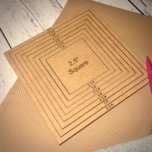May include: A brown wooden square template with concentric squares marked with measurements in inches. The largest square is 6 inches, and the smallest square is 2.5 inches. The text "2.5" Square" is printed in the center of the template.