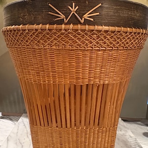 May include: A white ceramic mug with a black handle and the text "But First, Coffee" in a black, bold font. The mug is on a white surface.