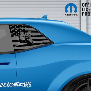 May include: A blue car with a black and gray graphic on the rear window featuring an American flag design and a cartoon image. The text "CUSTOMIZABLE" is at the bottom left, and the Mopar logo is visible.