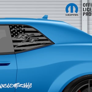 May include: A light blue car with a black and grey American flag design on the rear window. The design includes the letters "R/T" and the text "Customizable". The image also features the Mopar logo and the text "OFFICIAL LICENSED PRODUCT".