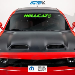 May include: A red Dodge Challenger with a black hood and a green "HELLCAT" windshield decal. The car has a sleek design with a prominent hood scoop and side mirrors. The image also includes the "MOPAR" and "OFFICIAL LICENSED PRODUCT" logos.