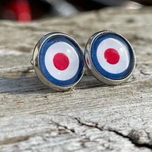 May include: A pair of silver stud earrings with a red, white and blue target design.