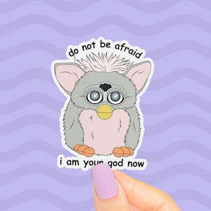 Cursed Furby Sticker, Do Not Be Afraid I Am Your God Now, Funny 90s Toycore, Weird Memes, Holographic Lovecraftian Horror, Worm on a String
