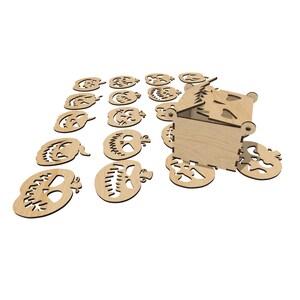 May include: A wooden box with a jack-o'-lantern design, open to reveal the inside.  The box is surrounded by 15 wooden jack-o'-lantern cutouts.
