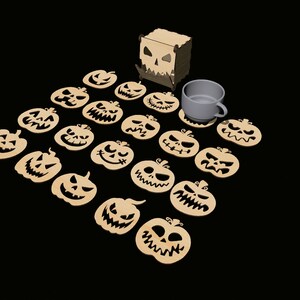 May include: A set of 20 wooden pumpkin-shaped coasters with carved jack-o'-lantern faces. The coasters are arranged in a semi-circle around a white ceramic mug. The coasters are packaged in a wooden box with a carved jack-o'-lantern face.