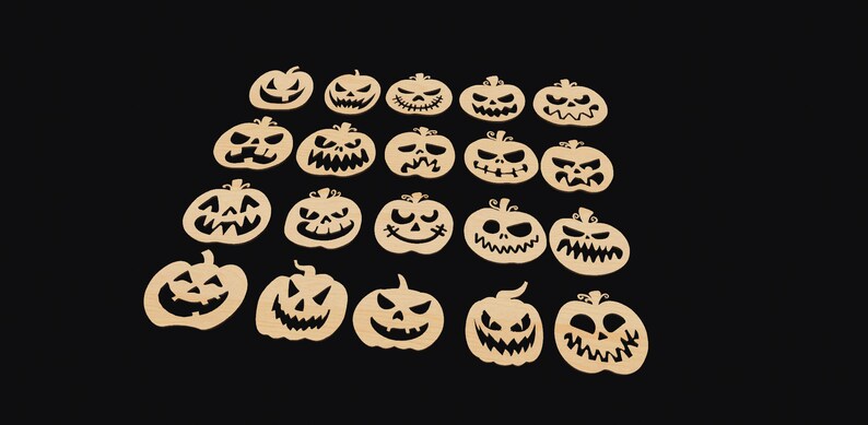 May include: Twenty wooden pumpkin cutouts with various carved faces. The pumpkins are beige and have black carved features.