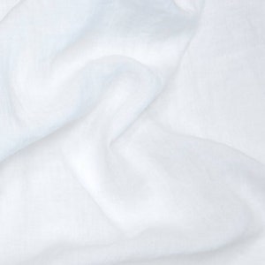 May include: White fabric with a soft, smooth texture. The fabric is wrinkled and folded, creating a natural, organic look.