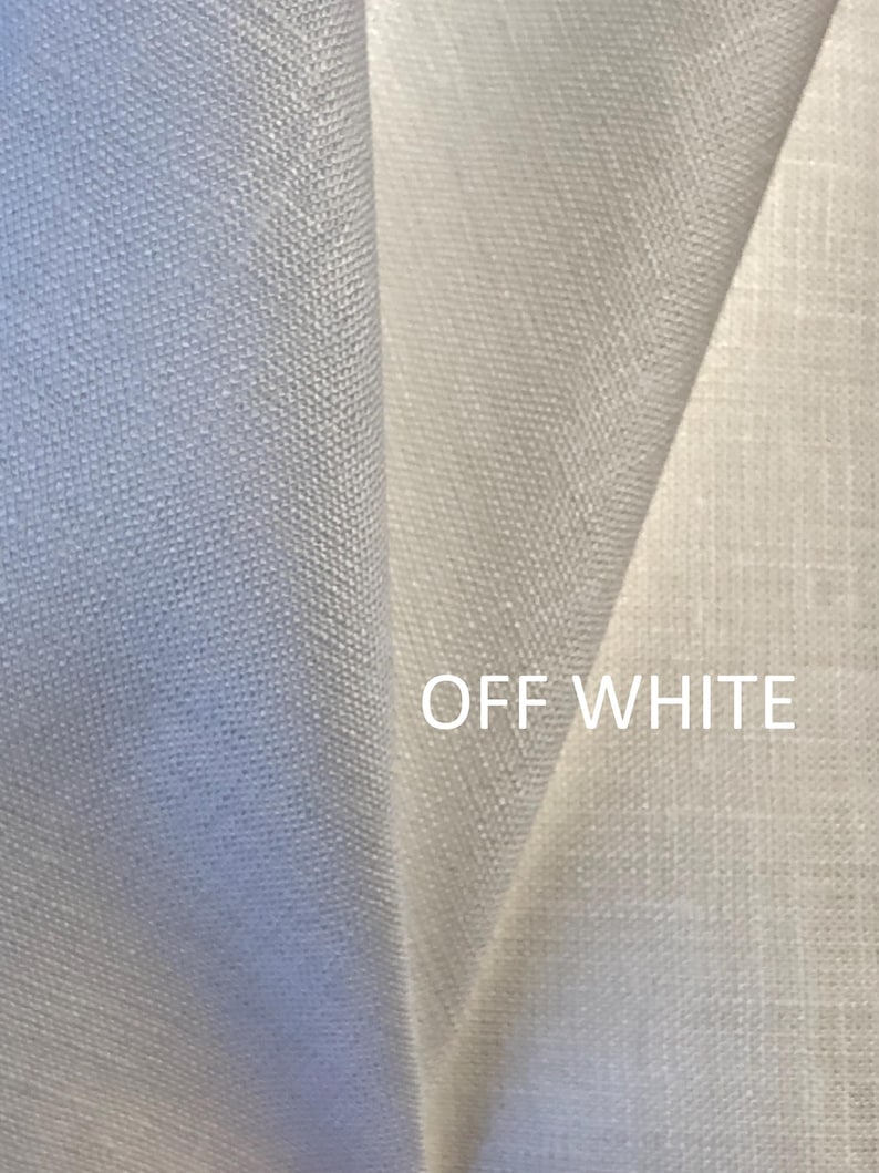 May include: A folded piece of off-white fabric with a visible woven texture. The material displays a consistent light colour throughout, and the text OFF WHITE is printed in a clean, sans-serif font on the lower right side of the fabric surface.