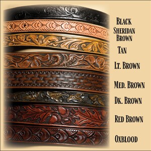 May include: A close-up of eight leather belts with different colors and embossed designs. The colors are black, tan, light brown, medium brown, dark brown, red brown, and oxblood.