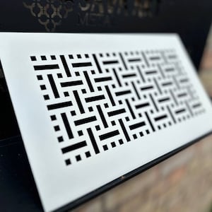 May include: White metal vent cover with a black geometric pattern. The vent cover is rectangular and has a smooth surface.