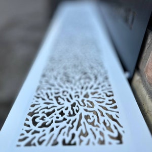 May include: White metal vent cover with a decorative cut-out design resembling a tree branch or coral.