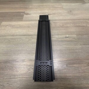 May include: Black metal vent cover with a perforated design and two metal clips on the sides.