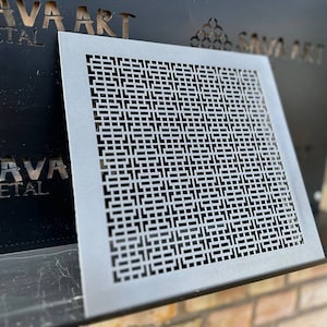 May include: A silver metal decorative panel with a geometric pattern of squares and rectangles. The panel is mounted on a brick wall. The text "SAVA ART METAL" is visible in the background.