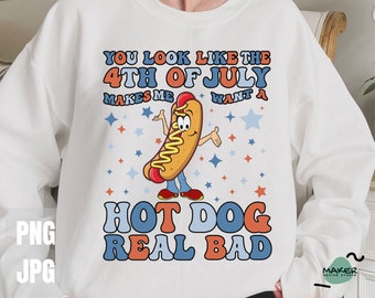 May include: White sweatshirt with a red, white, and blue hot dog graphic. The hot dog is wearing a blue shirt and has a red and white hat. The text on the shirt reads "You look like the 4th of July makes me want a hot dog real bad."