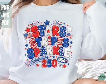 May include: White long-sleeve sweatshirt with a colorful graphic design. The design features the words "Stars Stripes Sparkle" in red, white, and blue, with stars, fireworks, and the text "Celebrating 250 USA".