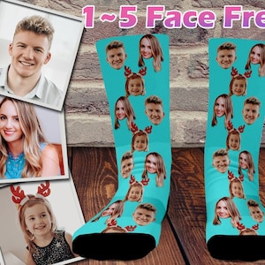 May include: A pair of turquoise blue socks with a variety of faces printed on them. The socks have a black toe and heel. The text "1-5 Face Free" is printed at the top of the image.